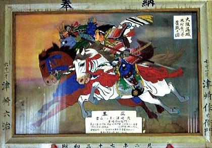 白と茶の馬に乗った槍を持った武士が描かれている木村長門守奮戦図の写真